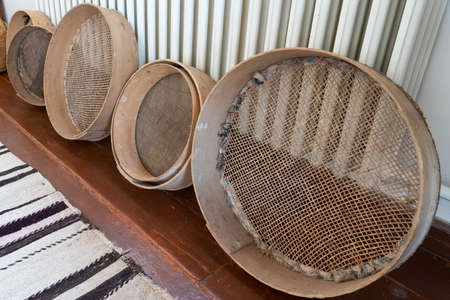 Old rusty sieves in a row.の写真素材