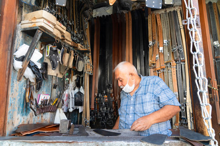 Gaziantep, Turkey-September 14 2020: Leather workshop master produces and sells belt various colorのeditorial素材