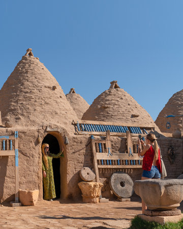 Sanli Urfa, Turkey- September 12 2020: Tourists posing in local clothes in front of harran houses.のeditorial素材