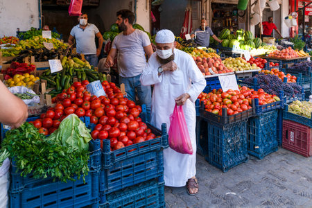 Mardin, Turkey-September 9 2020: Masked old muslim man shopping fruit and vegetables during...