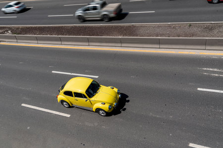 Ankara, Turkey - June 15 2021: Top view of yellow beetle car driving on divided roadのeditorial素材
