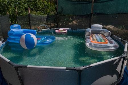 Blue plastic pool in the garden.