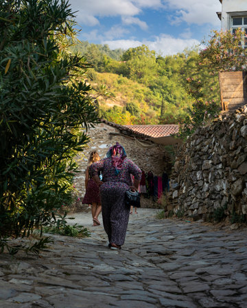 Sirince Village, Izmir, Turkey- August 23 20121: Back rear view of women walk on stone road in Sirince famous for traditional village houses.のeditorial素材