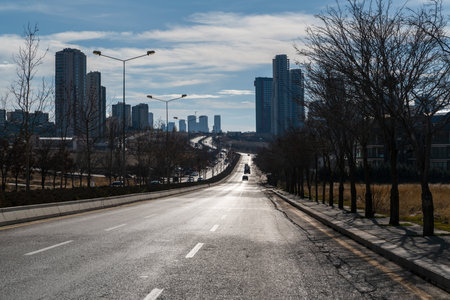 Ankara, Turkey - December 11 2021: The twisting asphalt road and tall buildings in the town of Incek.のeditorial素材