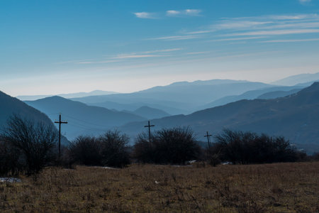 Silhouette of mountain with cross shaped electricity poles. Shamakhi, Azerbaijan.