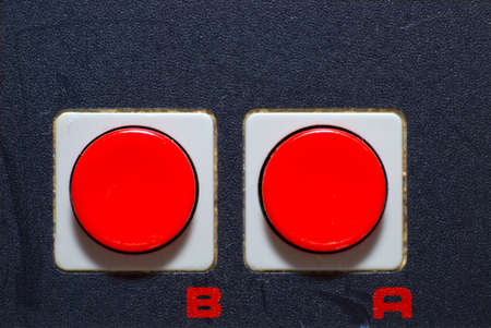 Close-up of classic retro hand control with red buttonsの写真素材