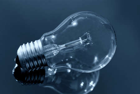 Close up of light bulb on a reflecting surfaceの写真素材