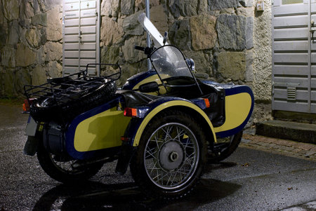 Old motorcycle with sidecar photographed at night
