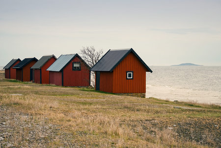 Red boathouses on the northern part of the Swedish island  Ã–land, the island BlÃ¥ Jungfrun ...