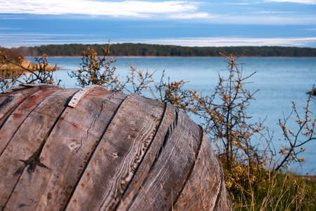 Old row boat in the foreground against blue sea and skyの写真素材