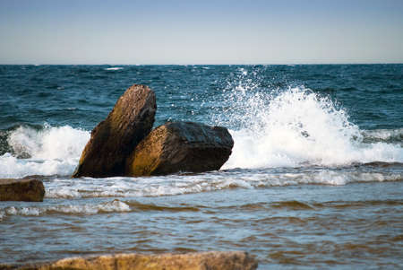 Big wave splash over rocky coastの写真素材