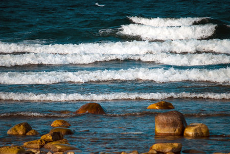 Waves rolling in to a rocky beach