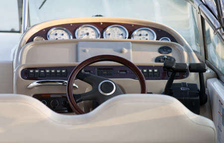 Exclusive boat controls, close up with focus on wooden steering wheelの写真素材