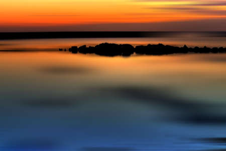 Beautiful sunrise, colorful sky and calm waterの写真素材