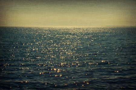 View of the ocean, aged and worn vintage style photoの写真素材