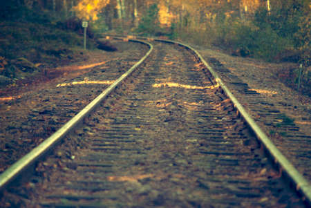 Railroad in evening light, aged and worn vintage style photoの写真素材