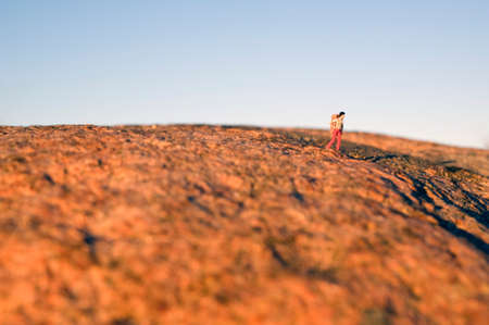 Woman hiking on the red mountain, miniature figureの写真素材