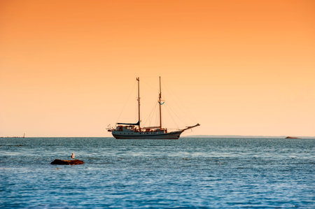Beautiful ship and orange summer sky
