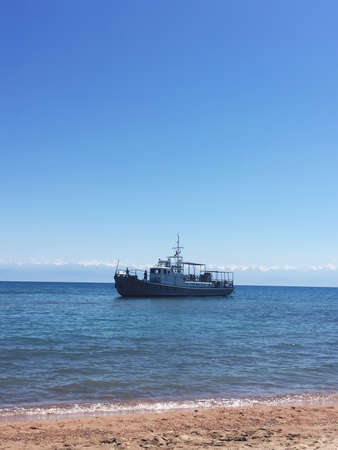 Issyk-Kul Lake, amazing nature, boat in lakeの写真素材