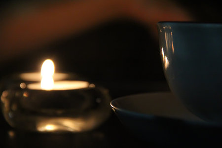 Half a cup of tea or coffe candles lit