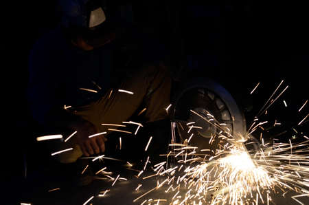 Electric wheel grinding on steel pipe in work space.の写真素材