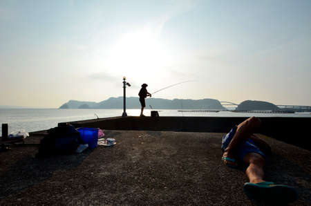 Japanese fisherman and the sea of dawnの写真素材