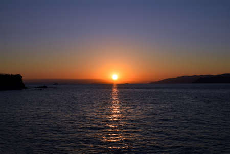 The winter sea and setting sunの写真素材