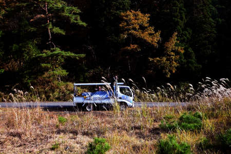 The man takes a photograph in the mountains of Kyoto, Japanの写真素材