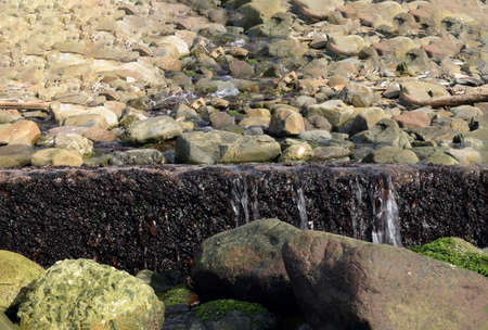 Japanese seaside small waterfallの写真素材