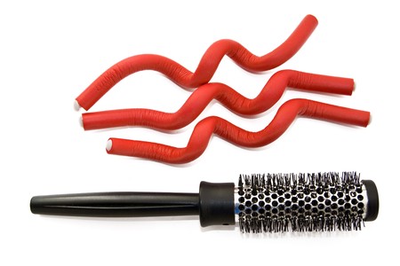 Hairbrush and hair curlers isolated on the whiteの写真素材