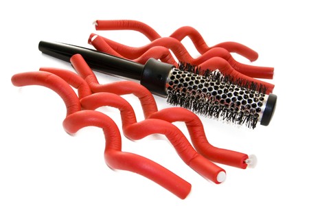 Hairbrush and hair curlers isolated on the whiteの写真素材