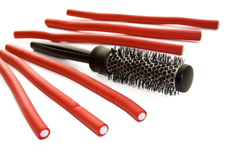 Hairbrush and hair curlers isolated on the whiteの写真素材