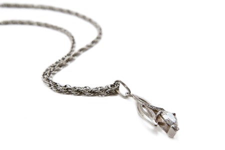 Silver pendant on a chain isolated on a white backgroundの写真素材