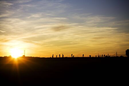 Driving range golf silhouette with players doing different thingsの写真素材