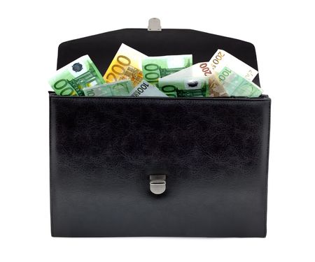 Black briefcase with money on a white backgroundの写真素材