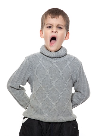 Cute boy yawning isolated on a white backgroundの写真素材