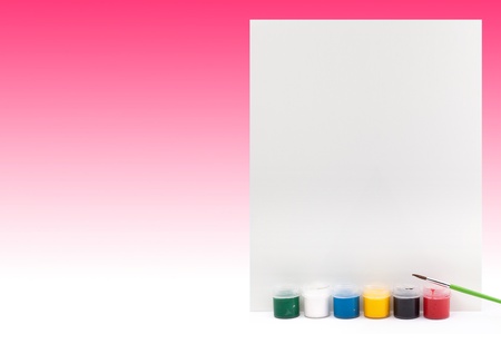 Paints with paintbrushes and paper on blue backgroundの写真素材