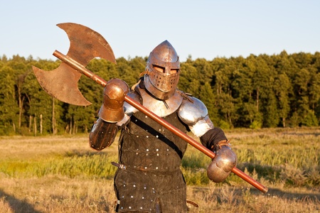 Medieval knight in the field with an axeの写真素材