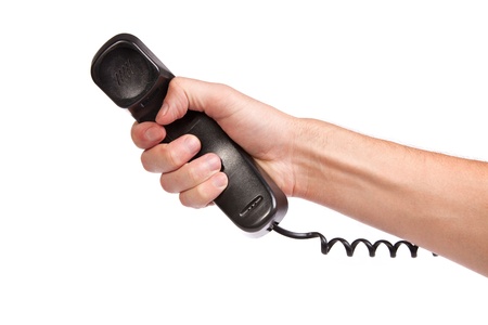 Hand holding an old black telephone tube isolated on white backgroundの写真素材