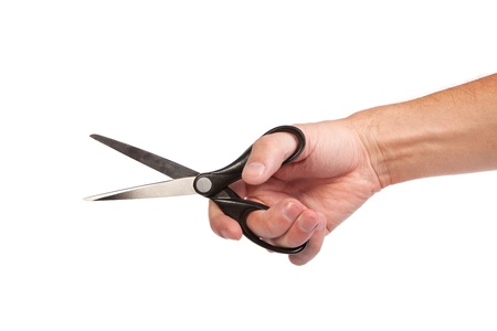 Hand is holding scissors isolated on a white backgroundの写真素材