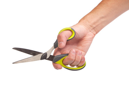 Hand is holding scissors isolated on a white background