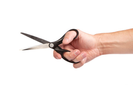 Hand is holding scissors isolated on a white background