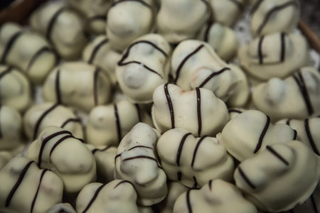 Chocolate candies of different shapes and broken pieces of chocolate. Delicious food background....