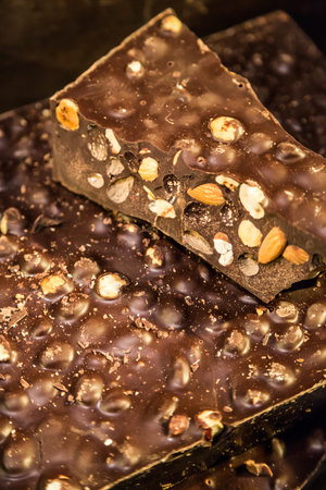 Chocolate candies of different shapes and broken pieces of chocolate. Delicious food background....