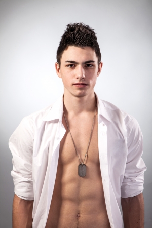 Healthy muscular young man. Isolated on grey background.の写真素材