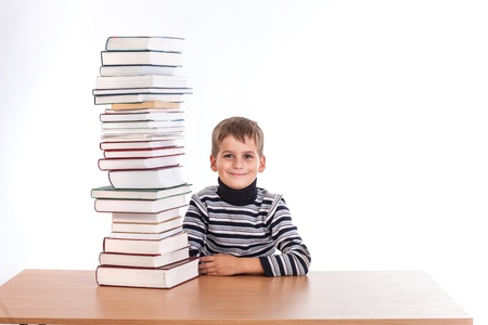 Schoolboy and a heap of books isolated on a white backgroundの写真素材