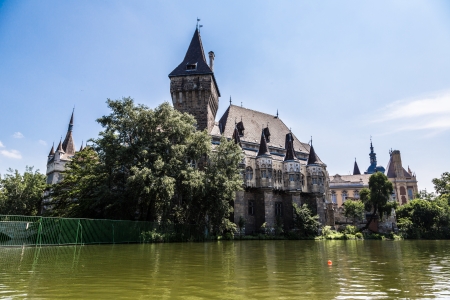 Historical building in Budapest - Vajdahunyad Castle with lake over the blue sky in main City Park. This is the similar castle like in Transilvaniaのeditorial素材