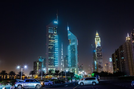 DUBAI - APRIL 18: Emirates Towers and Burj Khalifa at night time, 18 april 2013 in Dubai, UAE. Jumeirah Emirates Towers, Dubai's finest city hotel, is located in commercial business district.のeditorial素材