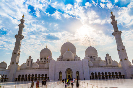ABU DHABI, UAE - JUNE 11: The Sheikh Zayed Grand Mosque, muslims and tourists on June 11, 2013 in...