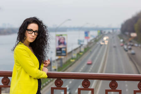A beautiful girl is  on a bridge outdoorの写真素材